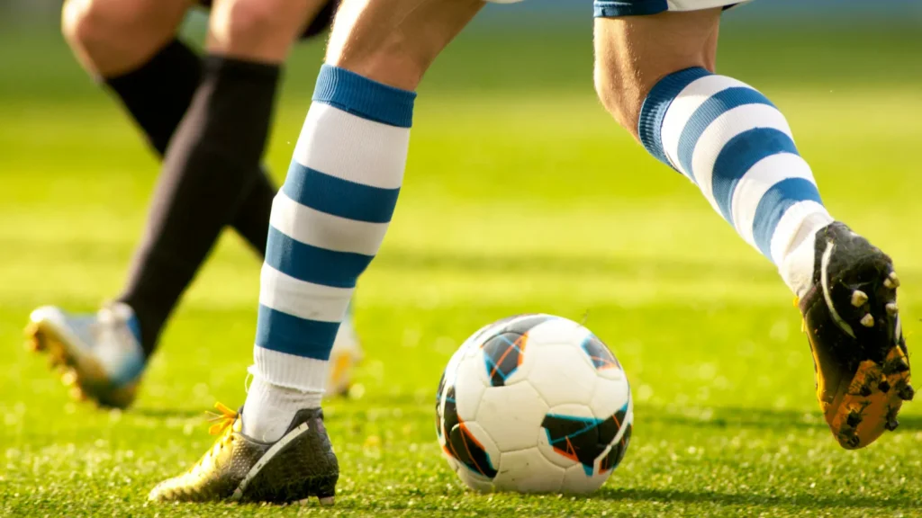 two soccer players vie