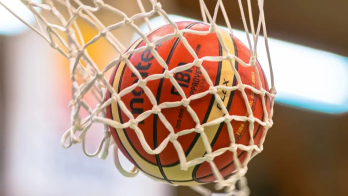 A basketball through a hoop A basketball through a hoop