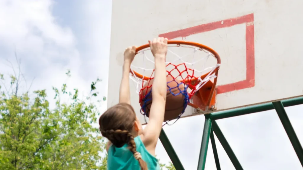 young teenager dunking a basketball
