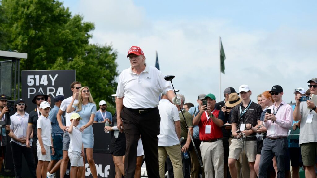 Former President Trump (C) walks off of the first Tee during the LIV Pro-Am held at the Trump National Golf Club in Bedminster,NJ.