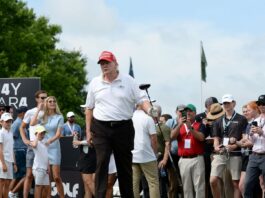 Former President Trump (C) walks off of the first Tee during the LIV Pro-Am held at the Trump National Golf Club in Bedminster,NJ.