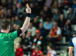a handball referee showing a twominute suspension sign with fingers