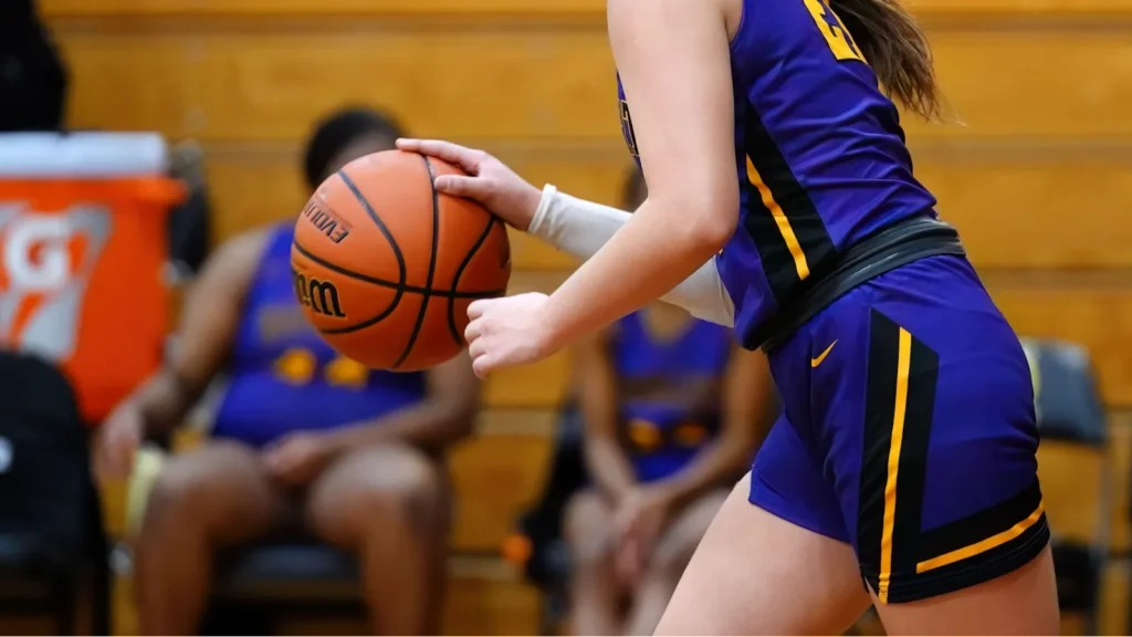 a young female player in a purple jersey on a