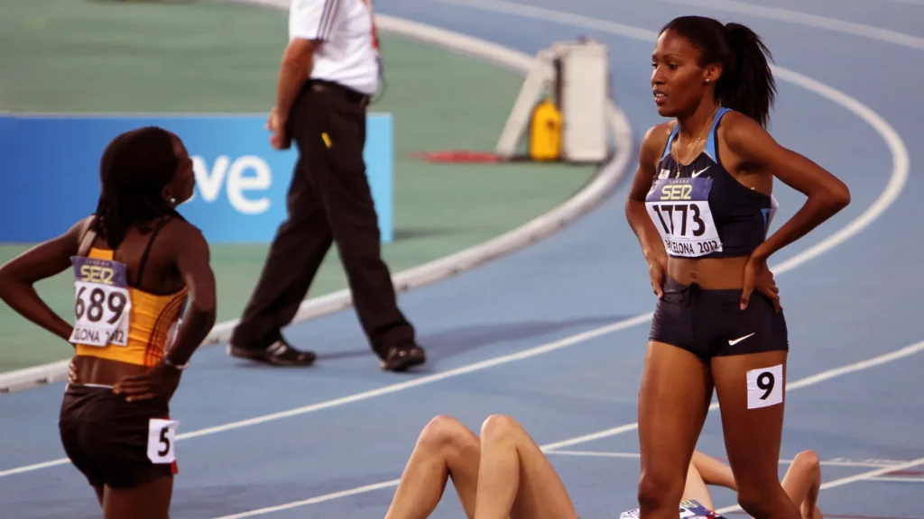 Young American athlete competes in an 800-meter race at a junior athletics championship.