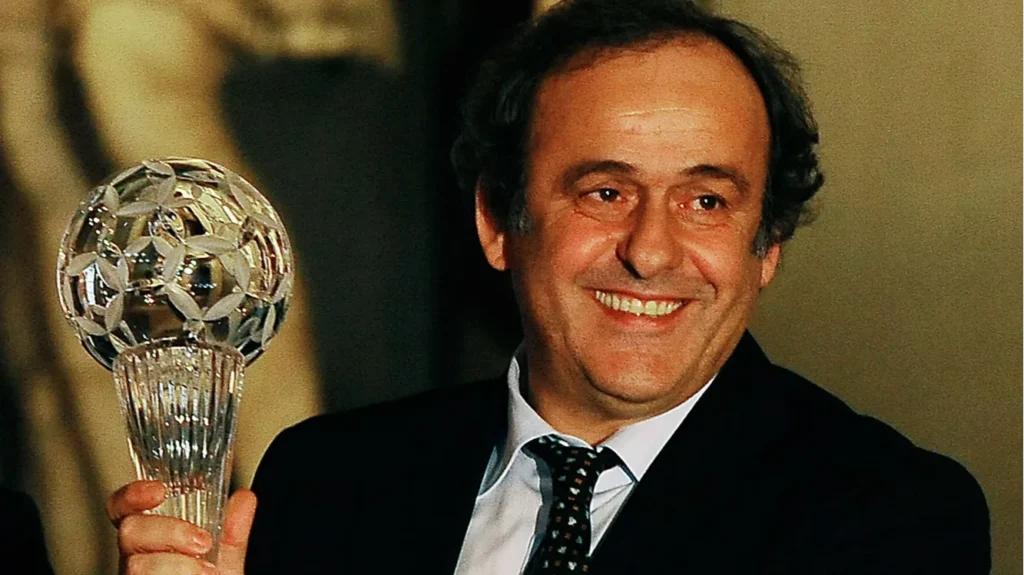 UEFA president Michel Platini holding a crystal trophy