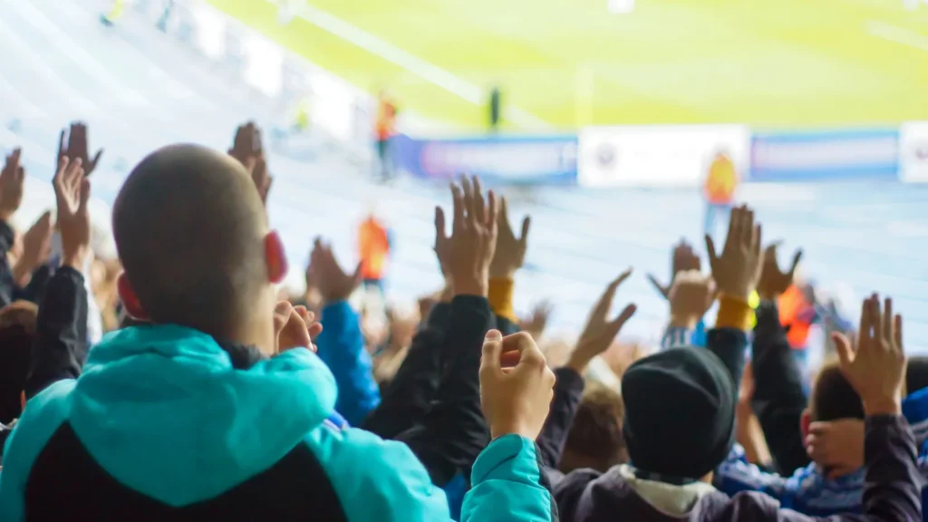 football fans clapping on the podium of the stadium