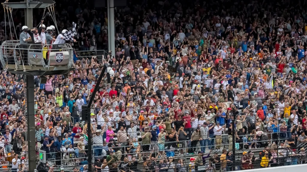 Massive, cheering crowd packed into the grandstands