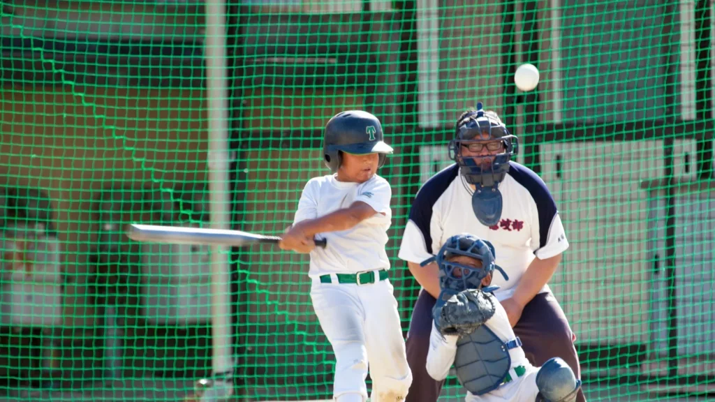 A Japanese kid playing baseball Little League concept