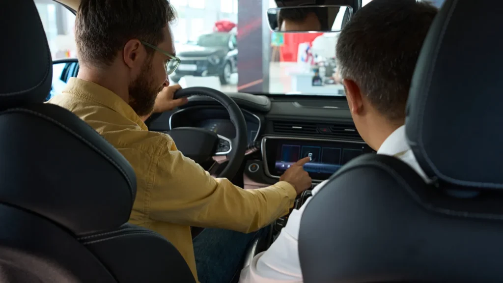 men sit in the interior of a modern car the