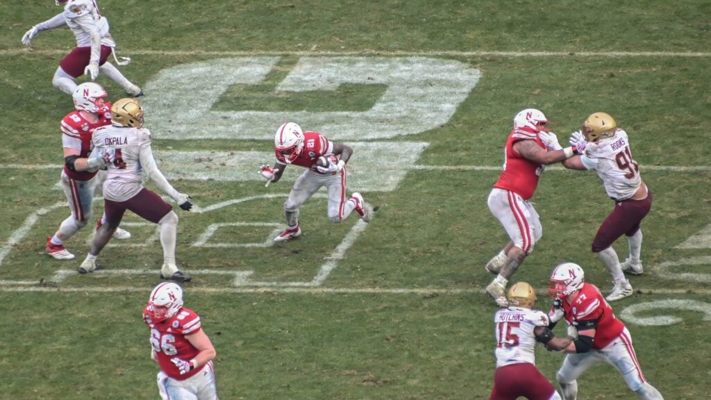 Emmett Johnson runs behind his blockers in the Pinstripe Bowl game with Boston College at Yankee Stadium