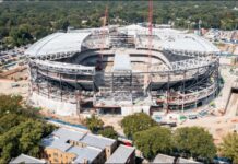 Inside Northwestern’s $870 million stadium that could change college football A large stadium under construction with steel framework and two red cranes over the open field center.