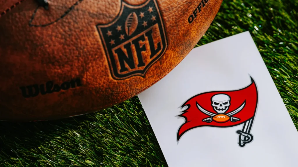 Tampa Bay Buccaneers logo next to a NFL football