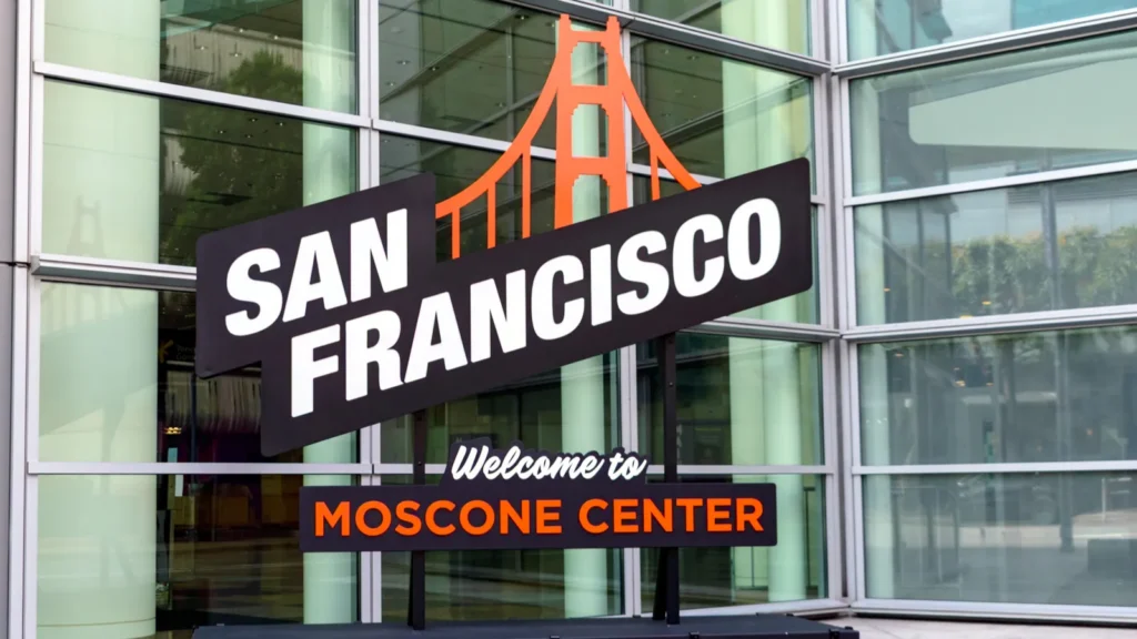 A Welcome to Moscone Center signs with a golden gate bridge icon