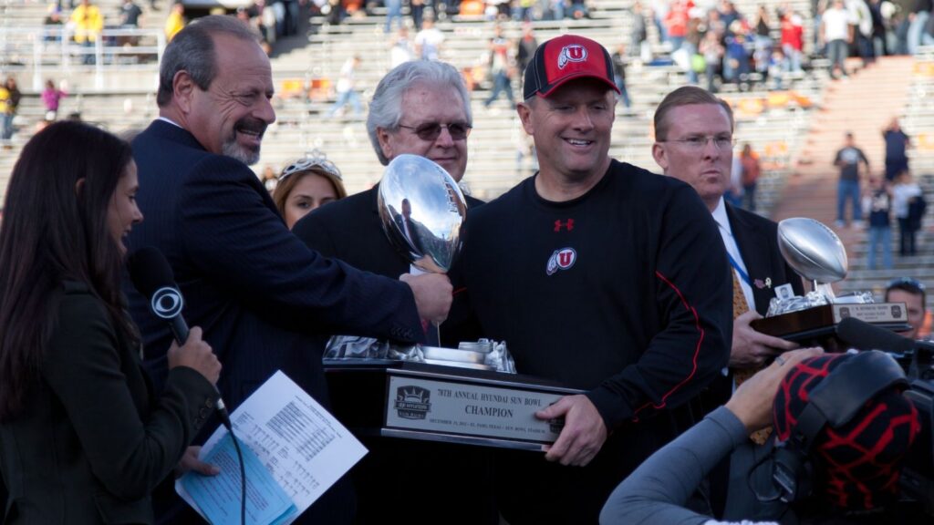Oscar Leeser presents the Sun Bowl Trophy to Kyle Whittingham.