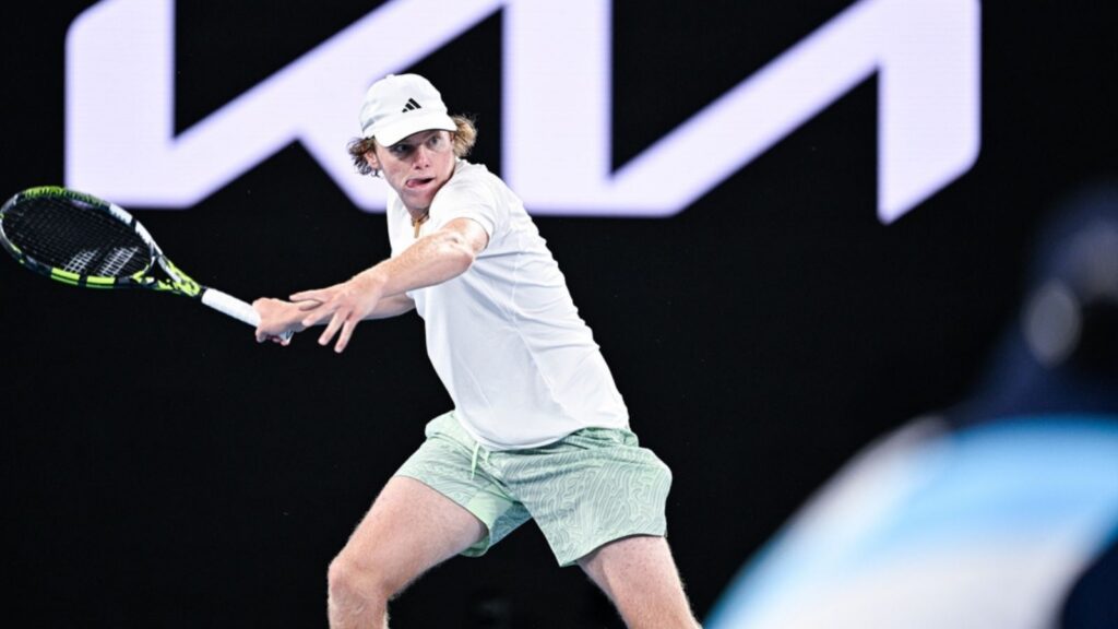 Alex Michelsen in action during a tennis match.