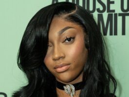 Angel Reese posing for the camera at an event.