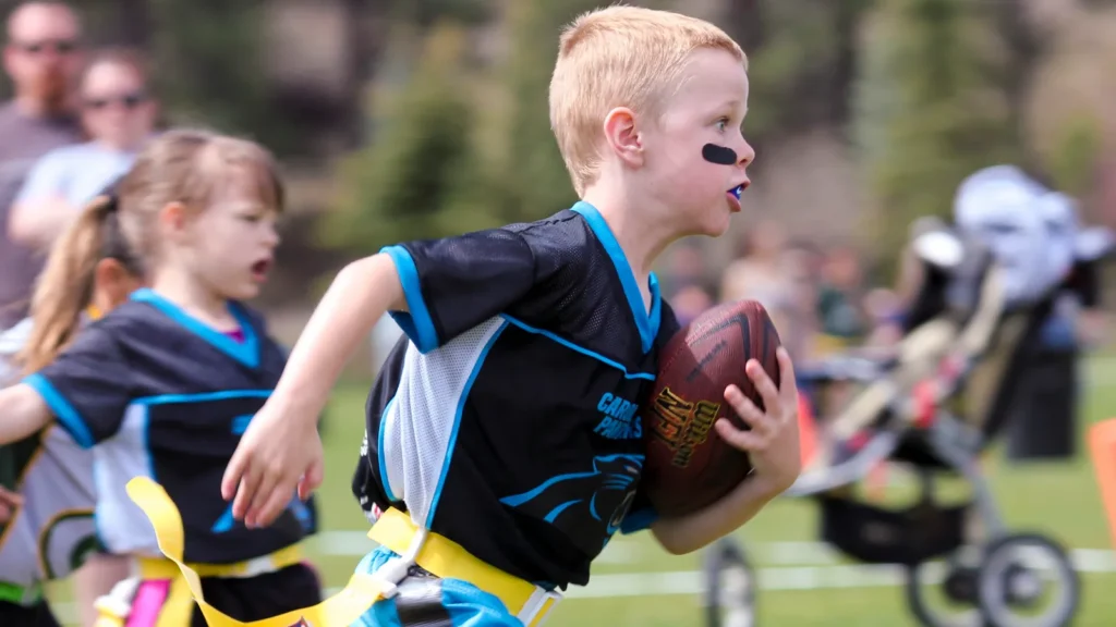 A flag football game being played for 5 to 6 year old kids.
