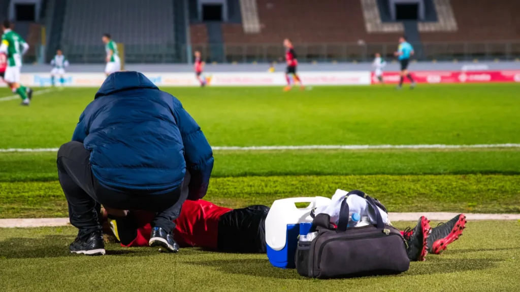 Sports doctor treating an injured athlete