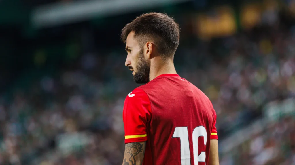 Álex Baena wearing Spain's national team jersey during a match.
