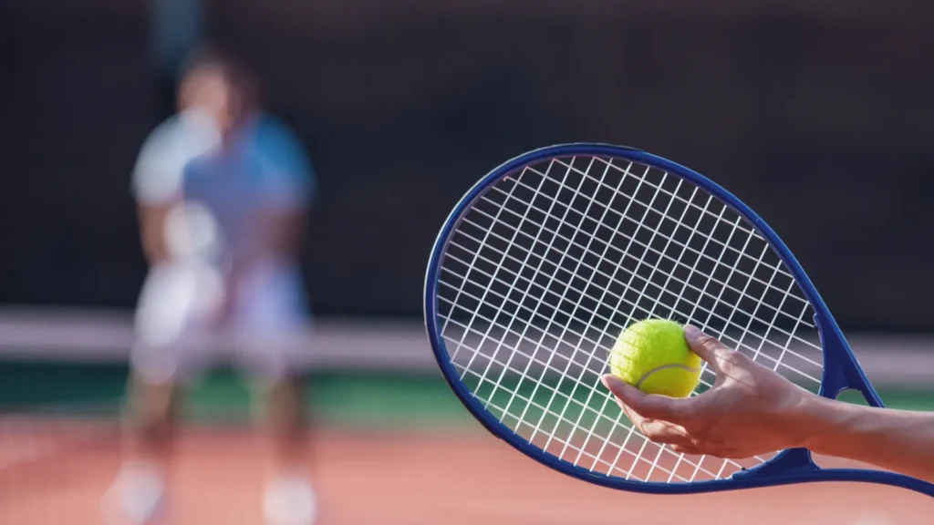 beautiful young couple is playing tennis outdoors on sunny weather