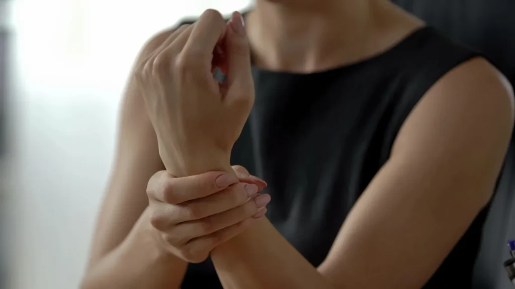 Cropped shot of a woman holding her injured wrist.