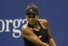 Naomi Osaka playing tennis in court.