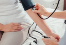 Denver Broncos cheerleader’s work outside the NFL raises questions about pay nurse measuring blood pressure to patient