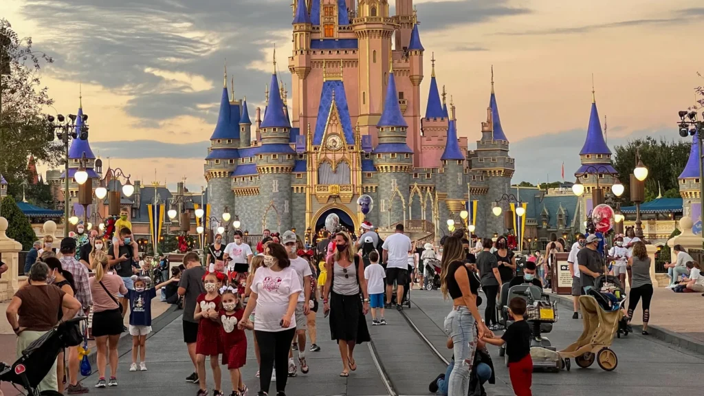 People walking toward Cinderella Castle during Christmas at Walt Disney World Magic Kingdom in Orlando, Florida.