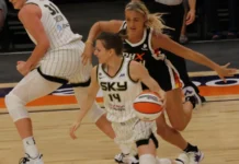 Sophie Cunningham chasing opponent player on the basketball court,