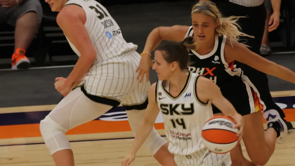 Sophie Cunningham chasing an opposing player on the basketball court