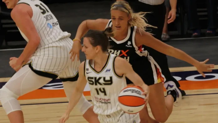 Sophie Cunningham chasing an opposing player on the basketball court Sophie Cunningham chasing an opposing player on the basketball court.