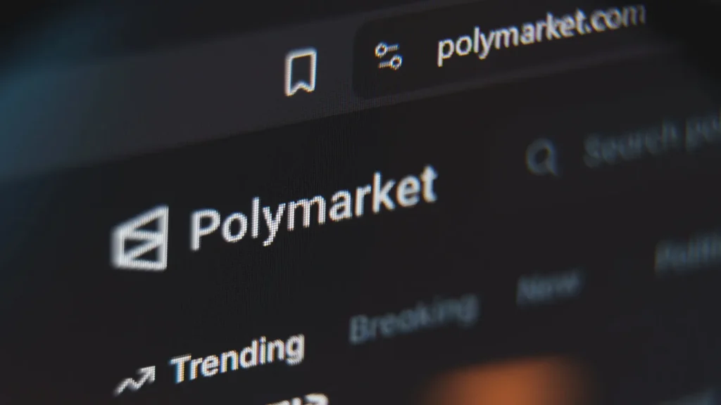 Polymarket prediction market website interface viewed through a magnifying glass