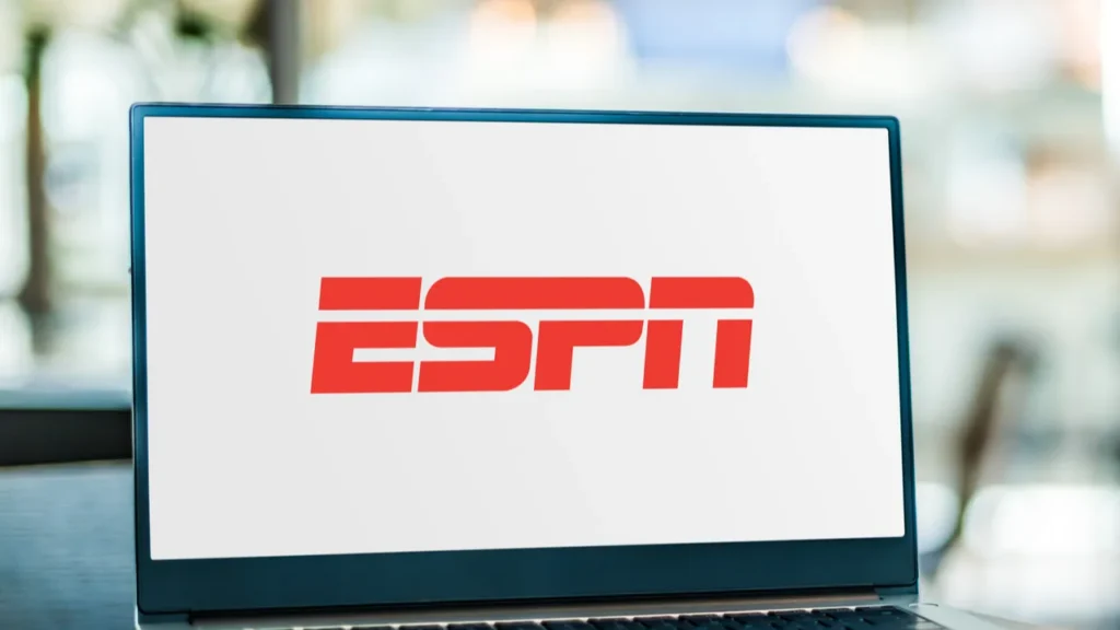 ESPN logo on a laptop screen placed on the table.