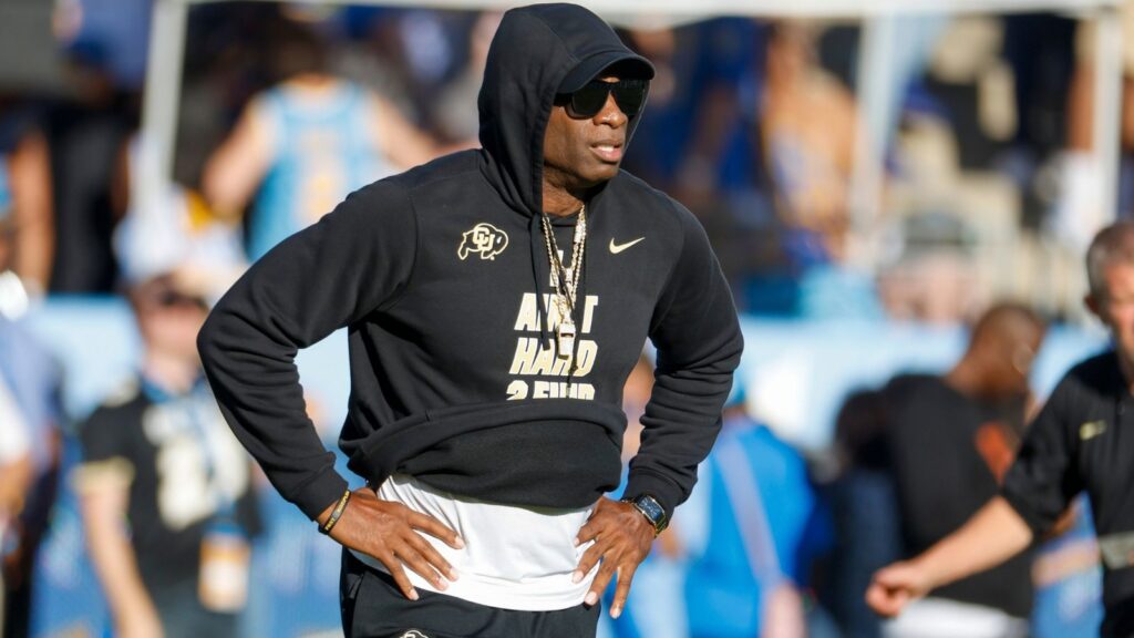 Deion Sanders looks on during a match.