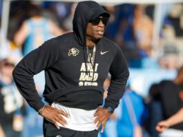 Deion Sanders looks on during a match.