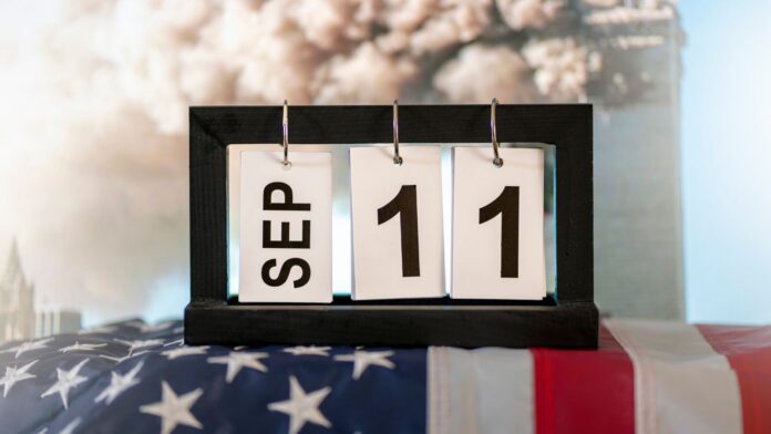 shutterstock_ 9 -11, september 11 concept_ 2343641415 1600x900 A calendar display set to September 11 resting on an American flag, symbolizing Patriot Day and the remembrance of the September 11, 2001 terrorist attacks.