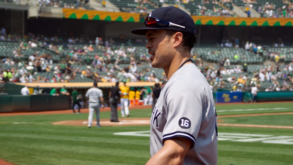 New York Yankees' Giancarlo Stanton #27 walks into the dugout before a game against Oakland Athletics at RingCentral Coliseum