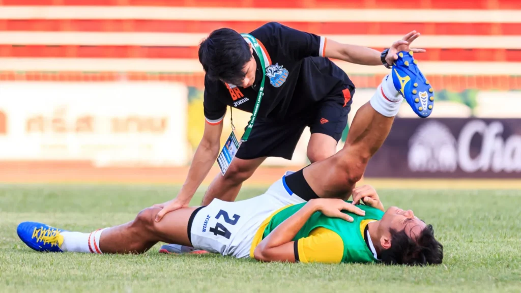 Physical therapists treating an injured player