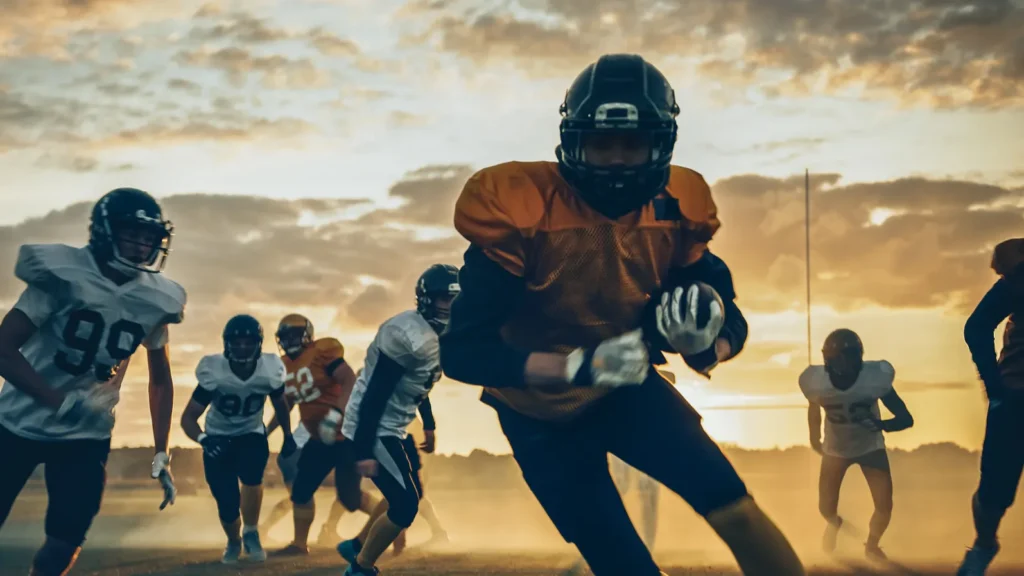 two professional american football teams stand opposite each other ready
