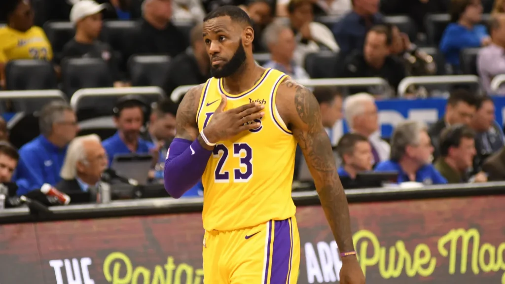 LeBron James placing his hand over his heart during a basketball game.