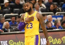 LeBron James placing his hand over his heart during a basketball game.
