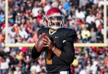 Quarterback Jalen Hurts holding ball during a game