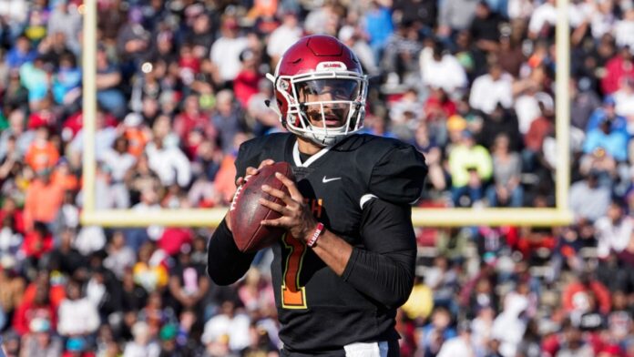 Quarterback Jalen Hurts holding ball during a game