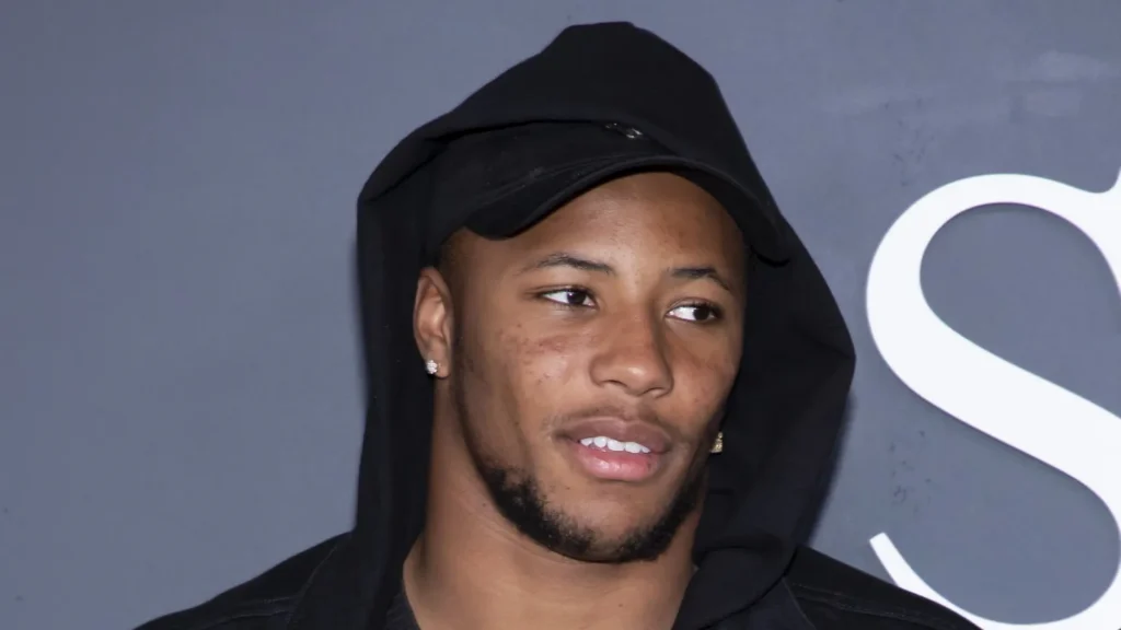Saquon Barkley during an event with grey background.