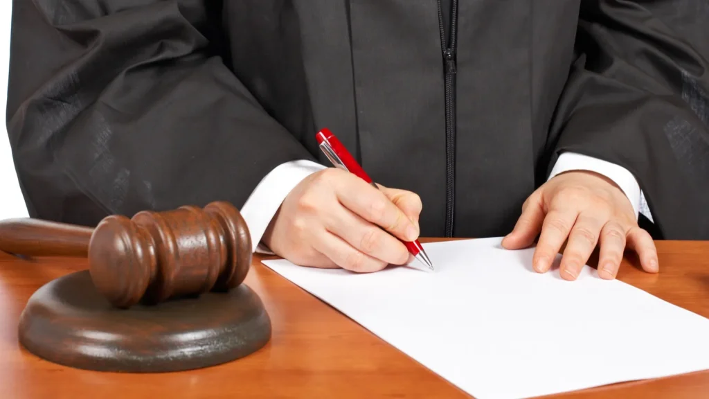 Female judge signing a court order.