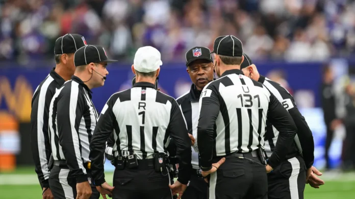 NFL referees between the game on the field.