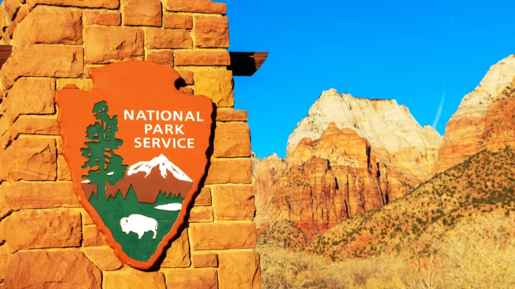 National Park Service arrowhead insignia outdoors.