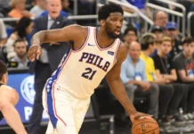 Joel Embiid running with a ball.