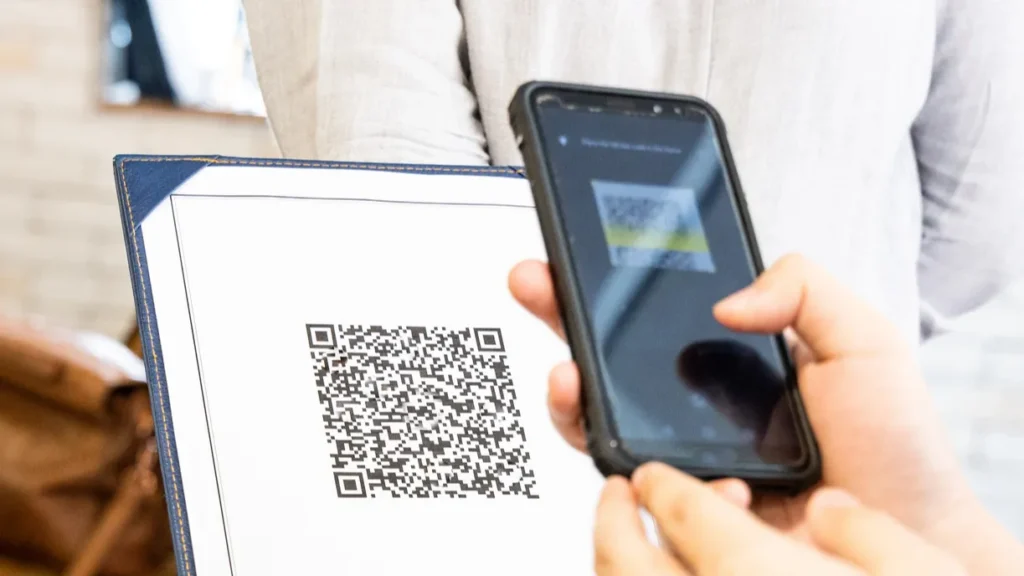 person scanning contactless menu qr code with smartphone as new