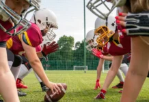 Kansas girls flag football championship halted following fatal crash photo of athletes women wearing white helmets playing american football